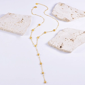 Exquisite gold stainless steel Y-shaped necklace featuring multiple heart charms on white marble