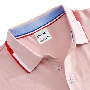 Detail of pink polo shirt collar and placket showing 100% polyester fabric texture