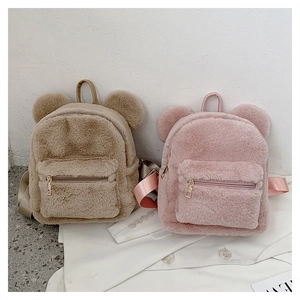 Detail of plush backpacks in khaki and pink with cute bear ears and front zipper pocket