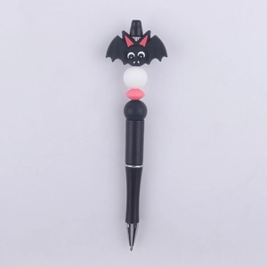 Detail of DIY beadable pen featuring a black cartoon bat topper and silicone beads