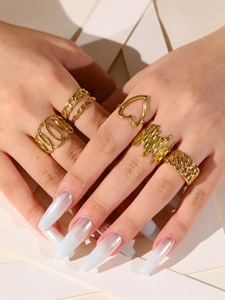 Detail of 18k gold plated stainless steel rings with heart and lava texture on hand