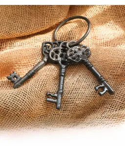 Detailed macro view of vintage style cast iron keys on rustic burlap background texture