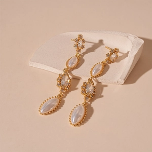 Detailed close-up of French vintage gold tassels earrings with marquise pearls and zircons