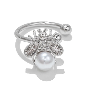 Detail view of silver bee ring with white pearl body and sparkling crystal wings