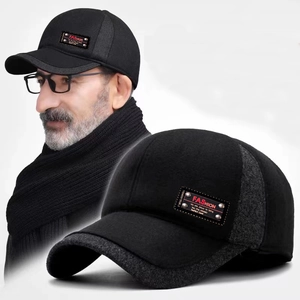 Detail of warm winter baseball cap showing thick gray fabric stitching and leather fashion tag