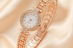 Detailed macro shot of gold rhinestone-studded ladies watch on luxury silk background