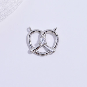 Elegant S925 silver pretzel pendant with sparkling zircon heart on white lace background