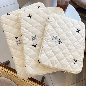 Quilted laptop sleeve with cute bow embroidery, soft padded computer bag for daily use.