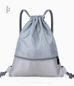 Close-up of gray waterproof nylon drawstring bag with hexagonal honeycomb texture and front zipper pocket