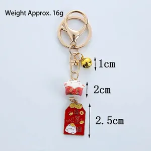 Japanese lucky cat ceramic keychain with golden bell and blessing tag, weighing 16g