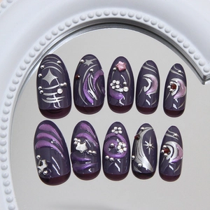 Dark purple pearl almond press-on nails with 3D stars, glitter, and ripple art design