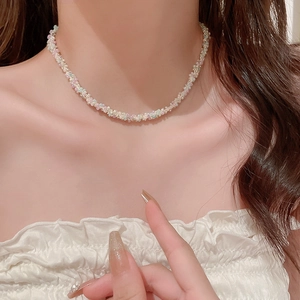 Gros plan d'un ras-du-cou fait main avec des perles colorées porté par un mannequin