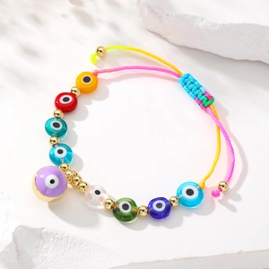 Detailed shot of vibrant woven bracelet with colorful evil eye beads and adjustable cord