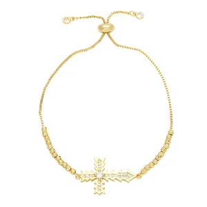 Elegant gold bolo bracelet with zircon cross pendant and adjustable metallic slider clasp