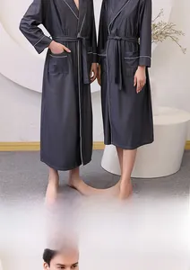 Close-up of charcoal grey waffle weave bathrobe showing texture, white piping and pockets