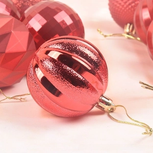Macro view of a 6cm red Christmas ball with alternating glossy and matte striped textures