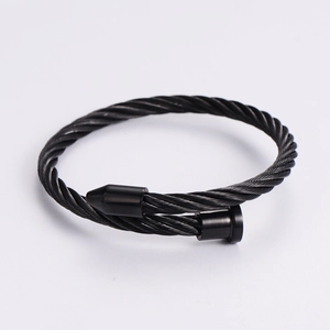 Minimalist black stainless steel cable bracelet with industrial cone and cylinder end caps