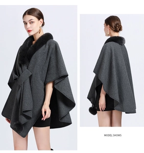 Front and back view of a dark gray knit poncho with black faux fur collar and pom-poms