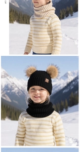 Detail of children's winter knit hat with dual pom-poms and matching neck warmer in snow