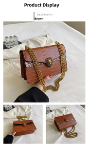 Detail of brown crocodile pattern shoulder bag with gold chain and lion head buckle