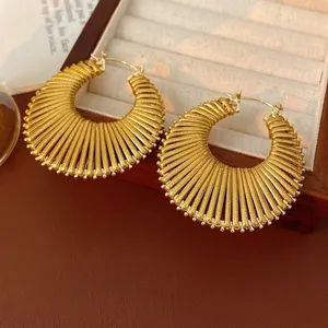 Golden round hollow hoop earrings with textured radial stripe engraving design