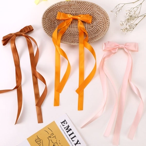 Detail view of double-layered satin ribbon bow hair clips with long streamers for girls