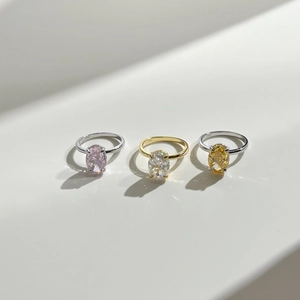 Close-up of S925 sterling silver rings with oval cut pink, white, and yellow gemstones