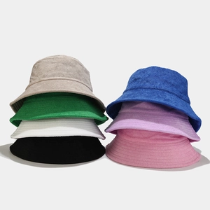 Detail view of colorful soft terry cloth bucket hats in seven different vibrant colors