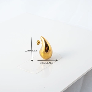 Macro view of gold teardrop earring with high-polish finish, size 32mm by 20mm