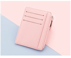 Detail of pink lychee texture leather card holder with three slots and side zipper