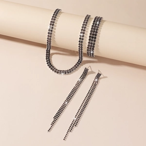 Detailed close-up of sparkling black rhinestone necklace, bracelet, and fringe earrings set