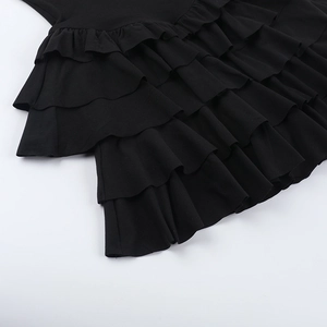 Detail of layered black ruffle design and pleated fabric on sexy backless summer dress