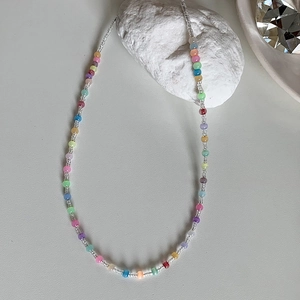 Colorful beaded choker necklace with vibrant summer style rainbow seed beads and cat eye stones