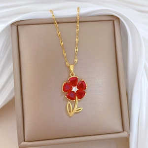 Elegant gold titanium necklace with red flower pendant and crystals on white silk