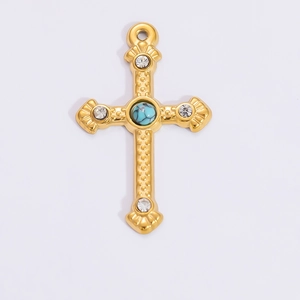Detailed close-up of a golden cross pendant with sparkling rhinestones and a turquoise bead