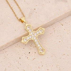 Detailed close-up of 18K gold-plated cross pendant with shimmering zircon inlays