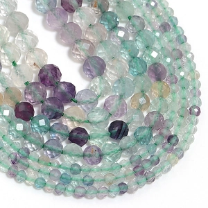 Macro view showing faceted natural fluorite beads in purple and green crystal textures