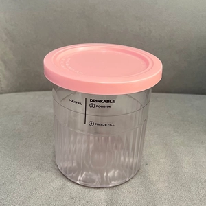 Detail of transparent Ninja Creami pint with pink lid showing max fill line and measurements