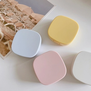 Set of four pastel square contact lens cases in yellow, blue, pink, and white matte finish