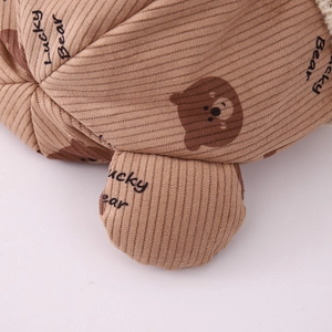 Detailed texture of brown corduroy hat featuring Lucky Bear print and cute ear design