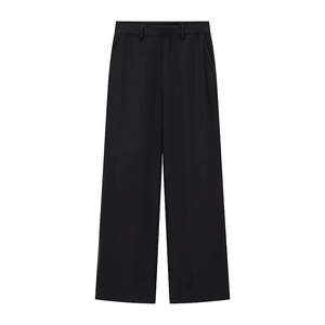 Detail of high-waisted wide-leg black trousers with elegant drape and smooth texture