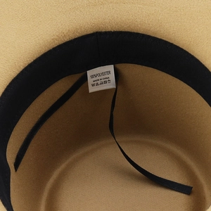 Detail view of khaki western hat interior showing 100% polyester label and sweatband