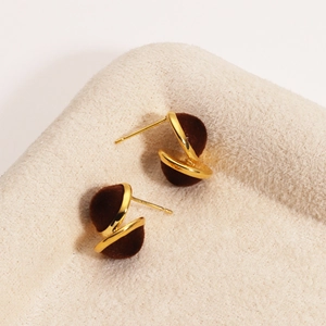 Detailed view of 18K gold plated stud earrings with deep brown velvet flocking balls