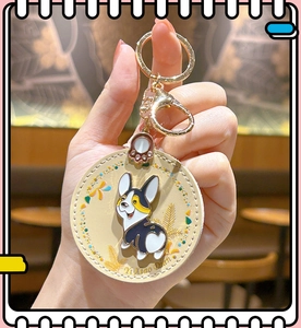 Detail of cute Corgi leather keychain with round pendant and metal lobster clasp