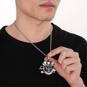 Detailed close-up of a silver pirate skull pendant with naval warrior engraving