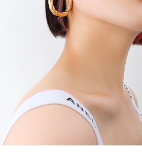 Detail of twisted rope texture on 18k gold plated hollow hoop earrings for women