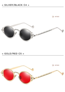 Detail of vintage steampunk sunglasses showing intricate metal carving and oval frame design