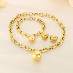 Detail of gold chunky O-chain jewelry set with large spherical pendants on satin background
