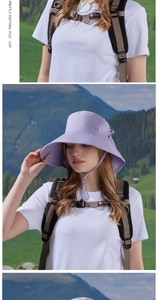 Detail of wide brim sun hat in lavender featuring a side metal logo and adjustable wind rope