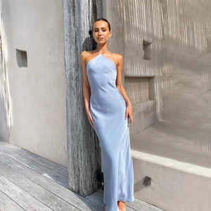 Detailed view of the smooth light blue satin fabric on the backless halter maxi dress